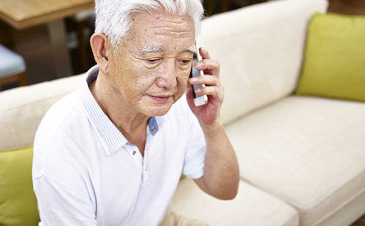 sad senior asian man talking on cellphone