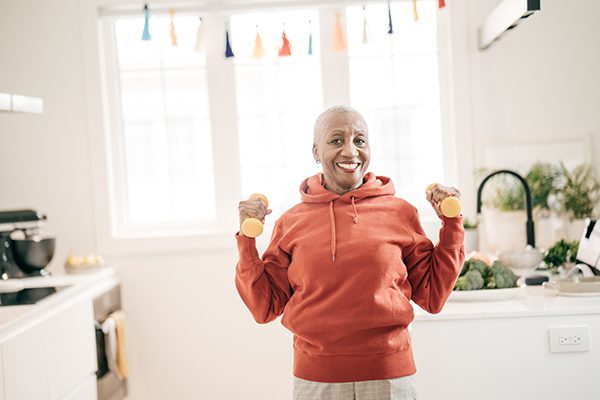 Senior women taking care of herself she exercise with dumbbells at home